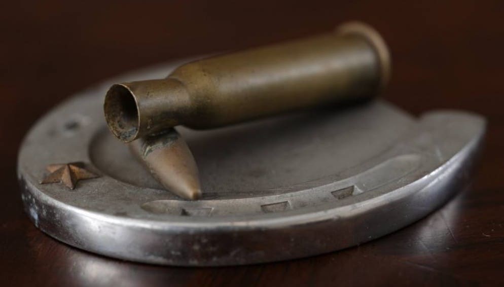 Bullet Case on  a Horseshoe Commemorative Paperweight.jpg
