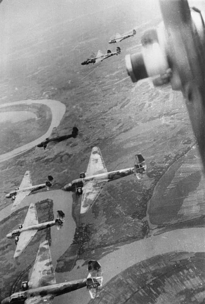 During a raid, Japanese Navy warplanes barrel through the air over the Chinese provision  capital, Chungking..jpg
