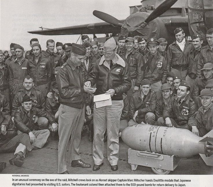 In an unusual ceremony on the eve of the raid, Mitchell crews look on as Hornet skipper Captain Marc Mitscher hands Doolittle medals that Japanese dignita.jpg