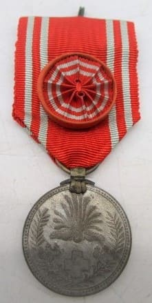 Japanese Red Cross Medal in paper wrapper.jpg