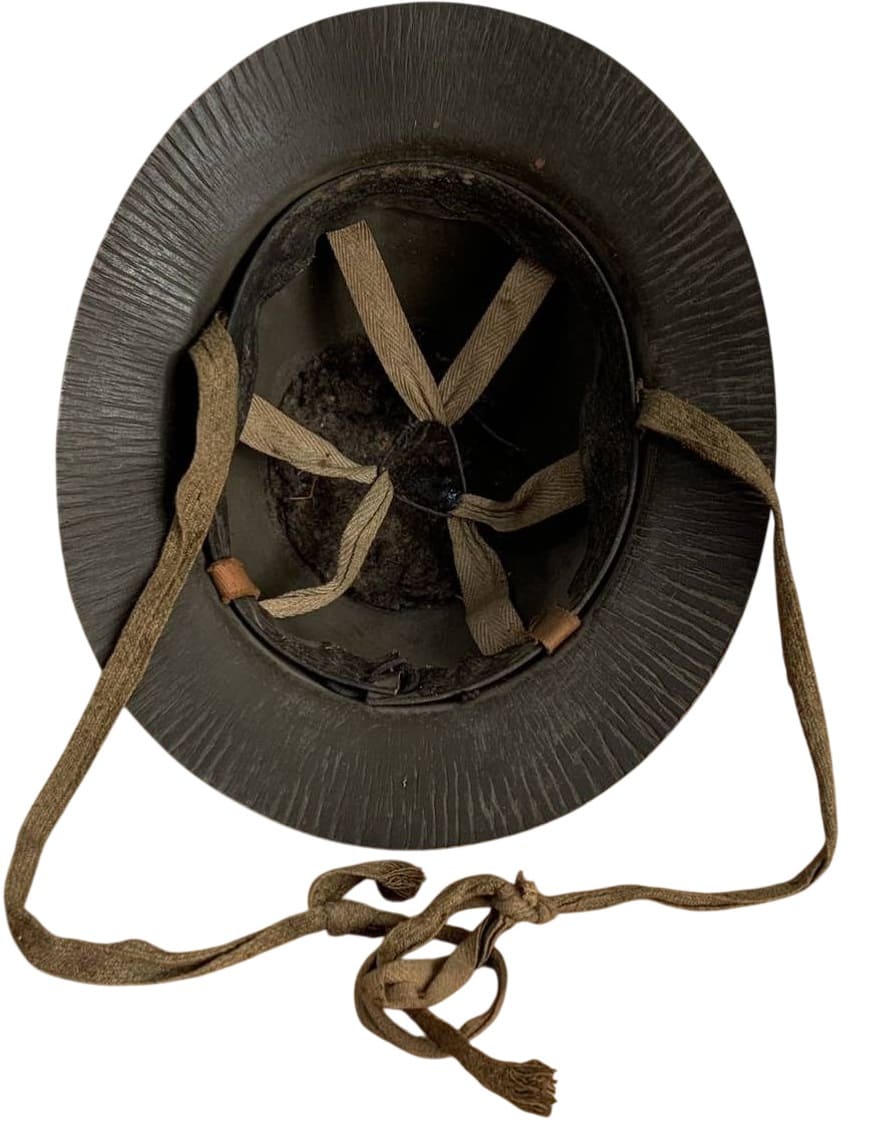 Wooden  helmet with large cap badge.jpg